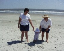 Rachel walking on the beach with Mommy and Aunt Kathy.