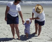 Rachel walking on the beach with Mommy and Aunt Kathy.