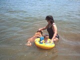 Rachel, mommy, and Teddy playing in the lake.