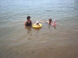 Rachel, mommy, and Grandma Jo playing in the lake.